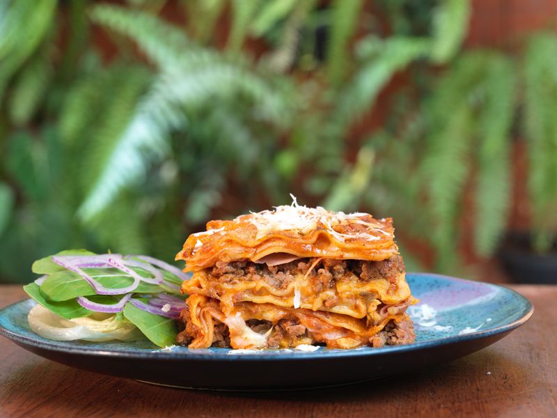 Rich tomato sauce layered in giordanos pizza preparation